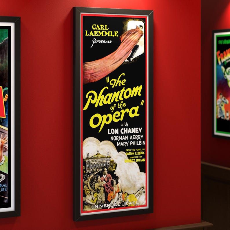 May include: Framed vintage movie poster for "The Phantom of the Opera" with Lon Chaney. The poster features a black background with yellow text and a dramatic image of a figure in a cape. The poster is in a black frame.