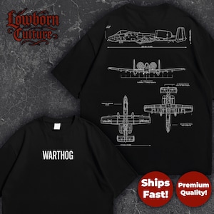 May include: Black t-shirts with white graphic designs of an A-10 Thunderbolt II aircraft. One shirt features the word "WARTHOG" in white block letters. The other shirt displays detailed blueprints of the aircraft.