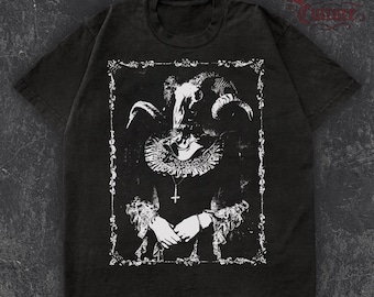 May include: Dark gray t-shirt featuring a detailed white graphic of a figure with a ram skull, ornate collar, and cross pendant. The design is framed by a decorative border. The text "Lowborn Culture" is at the top right.