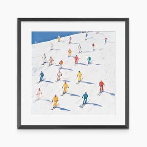 May include: A framed print featuring a vibrant scene of skiers descending a snow-covered slope. The skiers are dressed in colorful ski suits, including red, yellow, blue, and white, creating a dynamic and visually appealing composition against the white snow and blue sky.