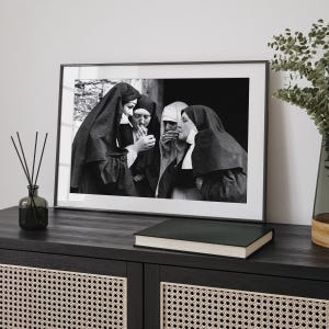a black and white photo of a nun and a nunette