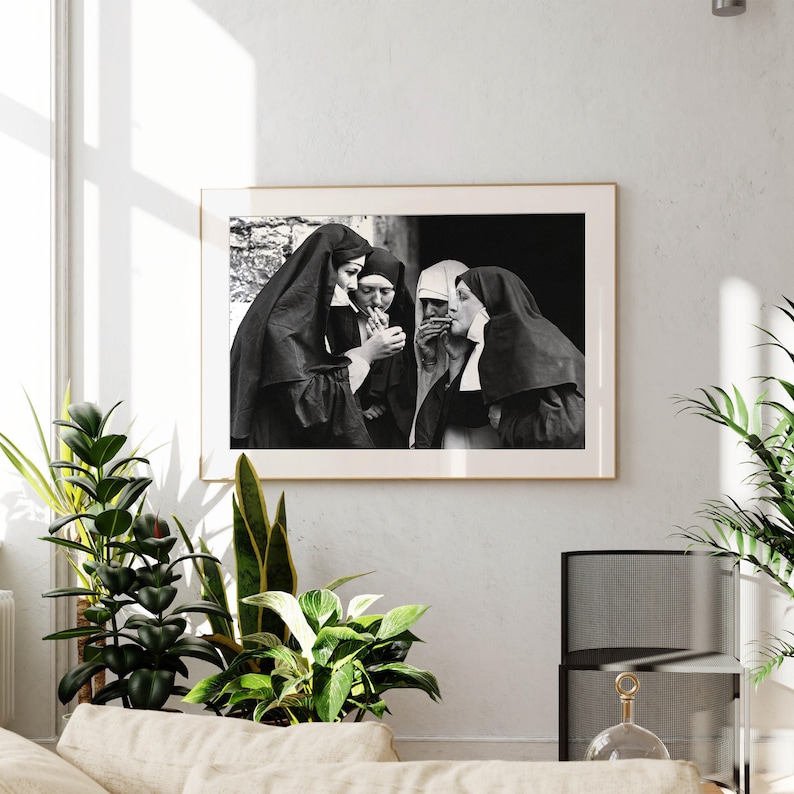 a black and white photo of a nun and a nun in a living room