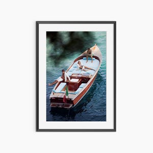 May include: A framed print of a wooden boat on the water with several people on board. The boat has blue cushions and an Italian flag. The water is a deep blue, and the sky is overcast.