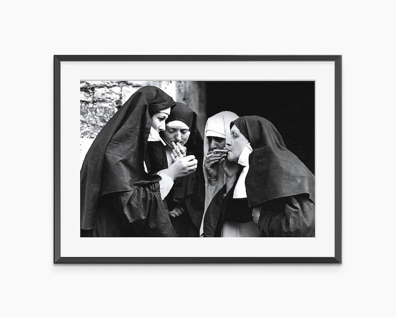 a black and white photo of two women dressed in nun costumes
