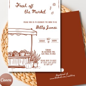 May include: A wedding invitation with a rustic design. The front features a market stall illustration with the text "Fresh off the Market" and details for the event, including the bride's name, date, and location. The invitation is on a woven background.