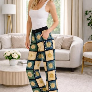 May include: Crocheted pants with a patchwork design in shades of green, yellow, and navy blue. The pants have a black waistband and a drawstring. The model is wearing a white tank top.