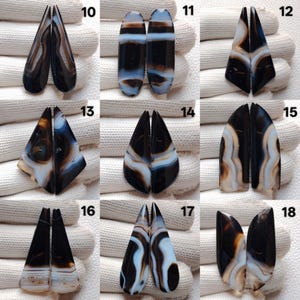 May include: A selection of paired agate gemstone cabochons in diverse shapes. The stones display black, white, brown, and blue banding patterns. Each pair is unique, showcasing natural variations in colour and design. Suitable for jewellery making.