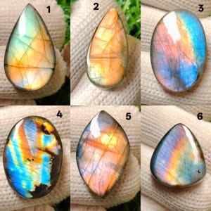May include: Six polished labradorite gemstones in different shapes. The stones show iridescent colours including blue, orange, yellow, and green. Each stone has a unique pattern and shape, suitable for jewellery making or collecting.