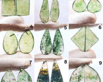 May include: Nine pairs of green gemstone cabochons in various shapes, including squares, teardrops, and triangles. The gemstones have a translucent appearance with green and white inclusions, and are displayed against a white background.