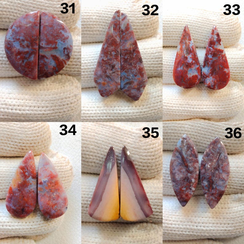 May include: A collection of six pairs of polished gemstones, each cut into different shapes. The stones display a mix of red, blue, and cream colors with unique patterns. The gemstones are numbered 31 through 36.