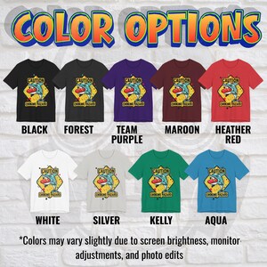 May include: A collection of nine short-sleeve t-shirts in black, forest, team purple, maroon, heather red, white, silver, kelly, and aqua. Each shirt features a graphic of a dolphin holding a red hot dog with the text CAUTION CHOKING HAZARD.