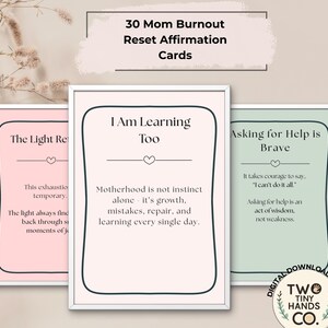 May include: Three framed affirmation cards with the text "30 Mom Burnout Reset Affirmation Cards." The cards are in pink, white, and green frames. The text on the cards includes phrases like "I Am Learning Too" and "Asking for Help is Brave."