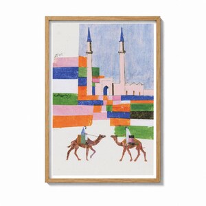 May include: A framed art print featuring a stylized illustration of two camels with riders in front of a mosque with two tall minarets. The composition uses blocks of vibrant colors including orange, green, blue, and pink against a white background.