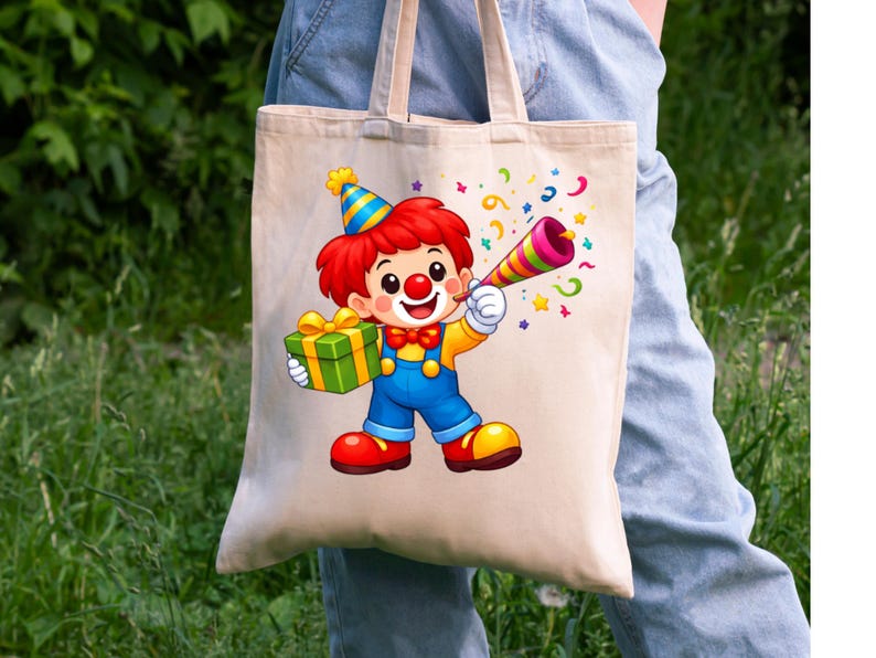May include: A beige canvas tote bag featuring a colorful cartoon clown illustration. The clown wears a blue and yellow party hat, red hair, a red bow tie, and blue overalls. The clown holds a green gift box and a multi-colored party horn.
