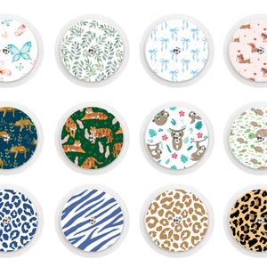 May include: Twelve circular stickers with diverse patterns. Designs include butterflies, leaves, bows, dachshunds, tigers, sloths, turtles, and leopard and zebra prints. Each sticker has a white border. Measurements are not applicable.