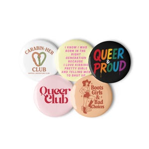 May include: A collection of five round buttons with various designs and text. One button says "CARABIN-HER CLUB", another says "QUEER & PROUD", and others feature phrases and illustrations related to LGBTQ+ themes.