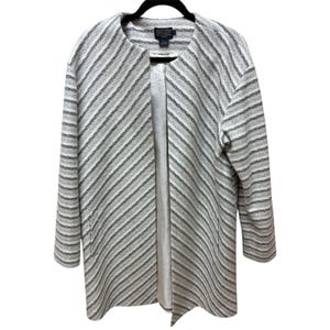 May include: A gray and white striped coat with a collarless design. The coat has long sleeves and two front pockets. The coat is hanging on a black hanger.