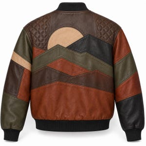 May include: A leather bomber jacket featuring a multi-coloured patchwork design on the back. The pattern depicts a landscape with a sun, mountains, and geometric shapes in shades of brown, tan, olive green, and black, with quilted leather panels.