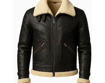 May include: Black leather jacket with a cream-colored shearling collar and lining. Features a zip-up front, two zippered pockets, and a buckled strap at the waist. The jacket has a classic aviator style.