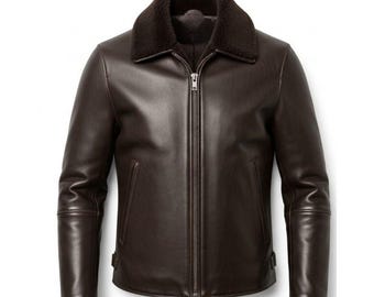 May include: A brown leather jacket with a dark brown shearling collar. The jacket has a full-length zipper and two side pockets. The sleeves have a tailored fit. This outerwear piece is designed for warmth and style.