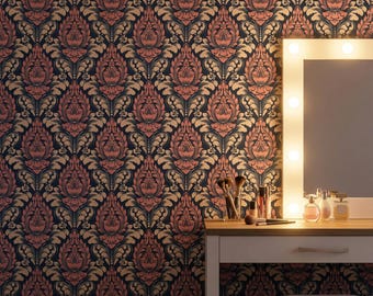 May include: A vanity table with a lighted mirror, makeup brushes, and perfume bottles set against a wall covered in dark wallpaper featuring a repeating damask pattern in shades of deep navy blue, muted coral pink, and metallic gold accents.