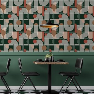 May include: Wallpaper featuring a geometric pattern of white arched lines, solid dark green rectangles, and terracotta circles. The design includes repeating curved shapes and vertical stripes on a dark green background, creating a structured visual rhythm.