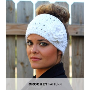 May include: White crochet headband with a flower detail. The headband is designed to be worn with a bun or ponytail.