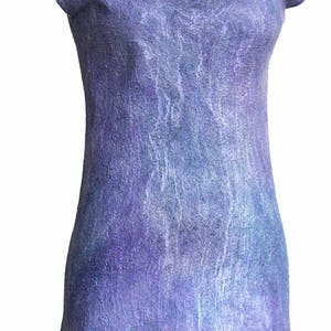 May include: A purple dress with a flower embellishment on the bodice. The dress has a scoop neck and short sleeves. The fabric has a textured, marbled look.