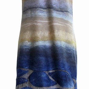 May include: A sleeveless dress with a blue and brown ombre pattern. The bottom of the dress features a design of blue shapes on a light gray background.