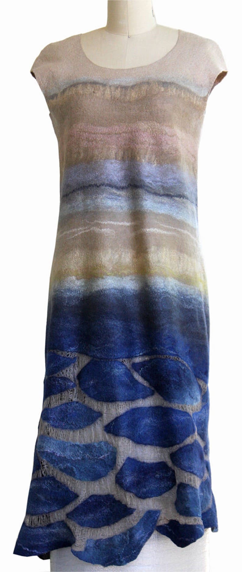 May include: A sleeveless dress with a blue and brown ombre pattern. The bottom of the dress features a design of blue shapes on a light gray background.