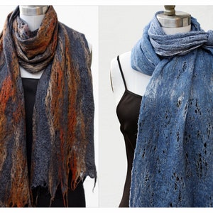 May include: Two scarves, one in a blue and brown color scheme and the other in a blue color scheme, are displayed on mannequins. Both scarves have a lacy, open weave pattern.