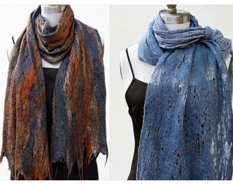 May include: Two scarves, one in a blue and brown color scheme and the other in a blue color scheme, are displayed on mannequins. Both scarves have a lacy, open weave pattern.