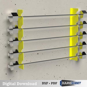 May include: A wall-mounted rack with four horizontal bars. The rack has yellow supports and silver bars with silver square end caps. The rack is mounted on a grey concrete wall. The words "Digital Download" are visible.