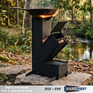 May include: A black metal rocket stove with a vertical chimney and an angled fuel feed chute containing burning wood. A cast iron skillet sits on the top burner. The text reads Digital Download Not a physical item DXF + PDF HARDSHEET.