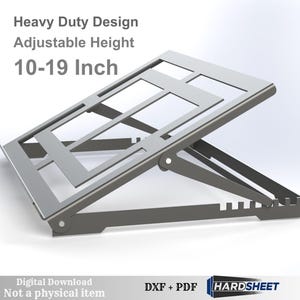 May include: A silver-colored, adjustable height stand with a heavy-duty design. The stand is designed to hold items between 10-19 inches. Text on the image reads "Heavy Duty Design, Adjustable Height, 10-19 Inch".