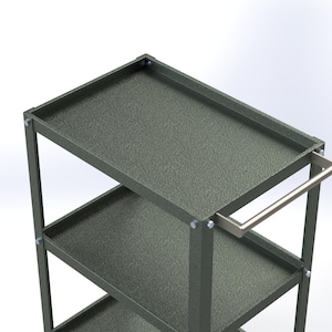 May include: A dark gray metal utility cart featuring three rectangular shelves with raised edges and a textured finish. The cart is constructed with vertical corner supports secured by silver-colored bolts and includes a horizontal handle on one side.
