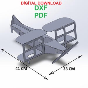 Pode incluir: Modelo de avião cinzento, projetado digitalmente, com hélice, asas e cauda. O modelo mede 41 cm de comprimento e 33 cm de largura. O texto em vermelho e verde indica um download digital disponível nos formatos DXF e PDF.