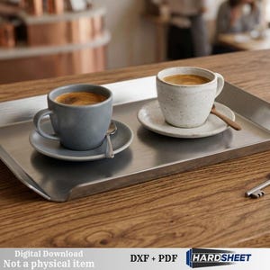 May include: A stainless steel serving tray holds two cups of coffee with saucers and spoons. One cup is grey, the other is white. A key rests on the wooden table. The text "Digital Download Not a physical item" is visible.