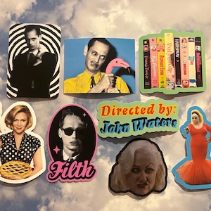 May include: A collection of colorful stickers featuring images of actors and film titles. The stickers include images of a man in a suit, a man holding a flamingo, and a woman holding a pie. Other stickers feature film titles and the text "Directed by: John Waters."