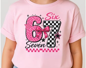 Puede incluir: Camiseta rosa claro con un diseño gráfico para un sexto o séptimo cumpleaños. El número 6 tiene estampado de leopardo, y el número 7 es a cuadros. La palabra "Six" es rosa, y "Seven" es negra.