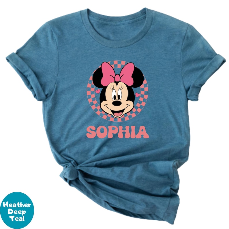 A blue t-shirt with a Minnie Mouse graphic and the name "Sophia" printed on it.
