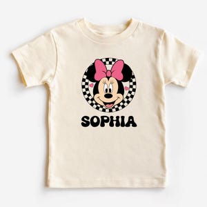 A white t-shirt with a Minnie Mouse graphic and the name "Sophia" printed below it.