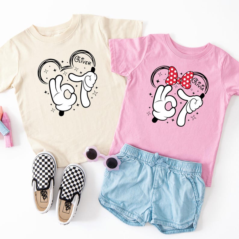 a casual outfit consisting of two children's t-shirts, a pair of shorts, and a pair of sunglasses.