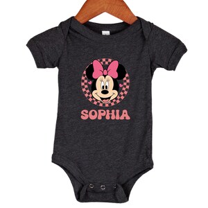 A gray baby onesie with a Minnie Mouse design and the name "Sophia" printed on it.
