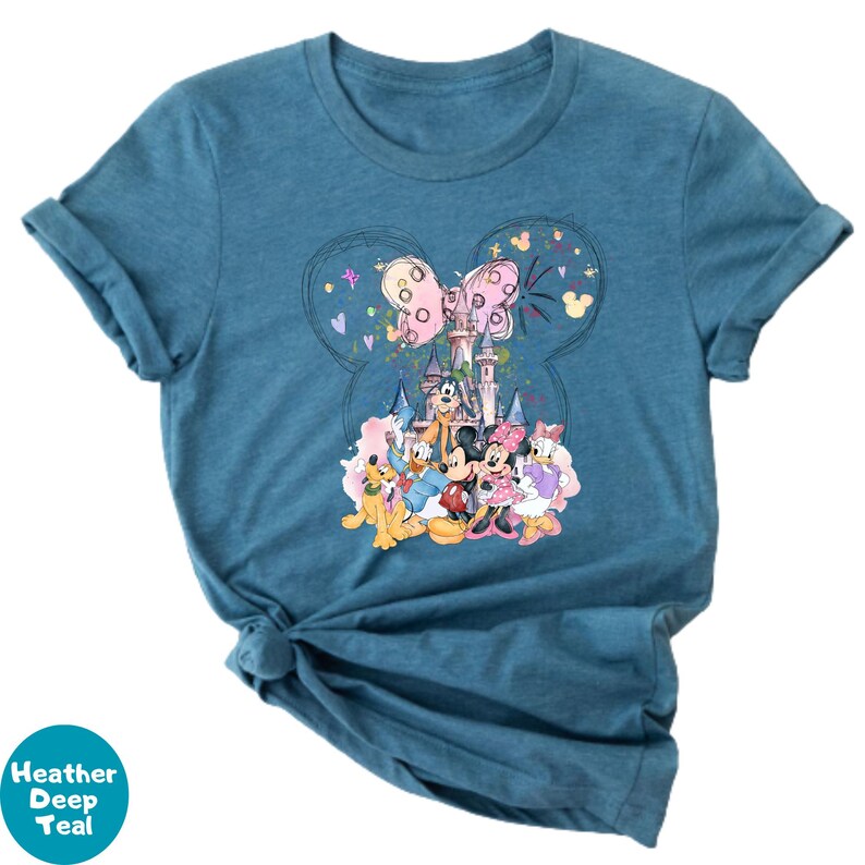 A blue t-shirt with a colorful graphic design featuring various Disney characters, including Mickey Mouse, Minnie Mouse, Donald Duck, and Goofy.