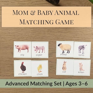 May include: A wooden sign that reads "MOM & BABY ANIMAL MATCHING GAME" sits above a set of matching cards. The cards feature illustrations of animals like a pig, sheep, and cat, with their baby counterparts. The set is labeled "Advanced Matching Set | Ages 3-6".