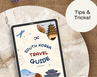 May include: A tablet displaying a South Korea Travel Guide with illustrations of landmarks and the South Korean flag. The text "Tips & Tricks!" is in a white circle. The background is a marble surface and a burlap texture.