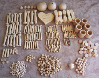 Large group of wood pegs, spoons, candle cups, plugs, spoons, and balls.  B735-1.