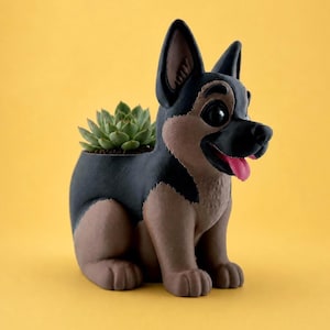 May include: A German Shepherd dog-shaped planter featuring a black and brown coat, upright ears, and a pink tongue. The planter contains a green succulent plant nestled in the back, with a smooth finish and a cartoon-like facial expression.