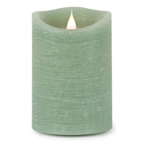 May include: A cylindrical sage green LED pillar candle with a textured, horizontal ridged surface. The top edge features a curved, uneven rim with a glowing white artificial flame centered in the middle, mimicking the appearance of a lit candle.
